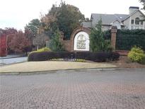 Welcoming McGill Park community entrance with brick signage and manicured landscaping along a quiet street at 1015 Mcgill Park Ne Ave, Atlanta, GA 30312