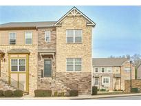 Charming multi-level townhome features a stone and brick facade with inviting staircase at 204 Mahnaz Dr, Atlanta, GA 30331