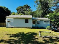 Charming single-story home with light blue siding and a well-maintained front lawn in a tranquil neighborhood at 2225 Misty Ln, Smyrna, GA 30080