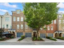 Charming townhomes feature well-maintained landscaping, private garages, and welcoming entrances at 291 Goodson Nw Way, Atlanta, GA 30309