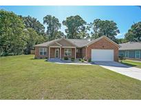 Beautiful single-story brick home featuring an attached two-car garage and well-manicured lawn at 686 Stark St, Lawrenceville, GA 30046