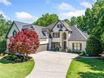 Stunning two-story home with meticulously landscaped front yard and a large driveway at 414 Dogwood Way, Canton, GA 30114