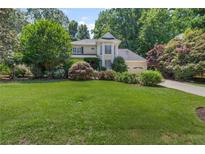 Charming two-story home with a well-manicured lawn and lush landscaping at 3231 Connemara Trce, Lawrenceville, GA 30044