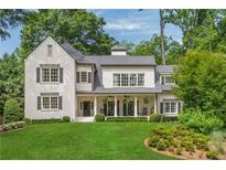 Stunning white brick home with manicured lawn and classic architectural details at 3894 Land O Lakes Ne Dr, Atlanta, GA 30342