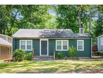 Charming single-story home with green siding, well-maintained lawn, and inviting front entrance at 936 Ormewood Se Ter, Atlanta, GA 30316