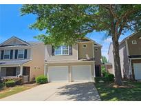Charming two-story home with a two-car garage and well-maintained front yard at 5465 Mountain Top Pl, Cumming, GA 30041