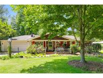 Charming single story home with brick facade, mature landscaping, and a cozy front porch at 4544 Ridgeview Dr, Powder Springs, GA 30127
