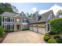 Beautiful two-story home with stone accents, three-car garage, and well-manicured landscaping at 2301 Kirk Farm Nw Pl, Kennesaw, GA 30152