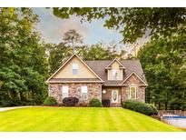 Charming stone and shingle home with manicured lawn and mature trees at 200 Scouts Ridge Dr, Covington, GA 30016