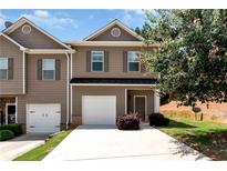 Inviting townhouse with a one-car garage and well-maintained landscaping at 5414 Sycamore Rd, Oakwood, GA 30518