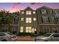 Charming townhome exterior featuring neutral colors, a manicured lawn, and well-maintained landscaping at 234 Riverstone Commons Cir, Canton, GA 30114