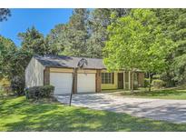 Charming brick and siding home with attached two-car garage and a basketball hoop in the driveway at 2948 Sagewood Dr, Snellville, GA 30039