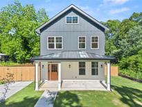 Charming two-story home features a welcoming front porch, gray siding, and well-manicured lawn at 327 Ohm Ave, Avondale Estates, GA 30002