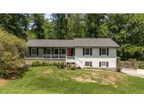 Charming split-level home featuring a landscaped front yard and a cozy front porch at 2795 Bentwood Dr, Marietta, GA 30062