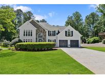 Beautiful home with a stone accent, two-car garage, well-manicured lawn, and tasteful landscaping at 5706 Brookstone Nw Walk, Acworth, GA 30101