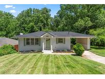 Charming single-story home with a well-manicured lawn and attached carport at 805 Gertrude Nw Pl, Atlanta, GA 30318
