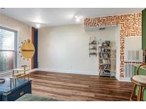 Bright living room featuring hardwood floors, wall decor, and large windows, perfect for relaxing or entertaining at 1195 Milton Se Ter # 2203, Atlanta, GA 30315