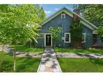 Charming blue house with a stone pathway leading to the front door and lush green lawn at 13795 Arnold Mill Rd, Roswell, GA 30075