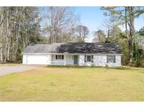 Charming single-story home featuring a welcoming front porch and well-maintained lawn at 2931 Oakwilde Ct, Snellville, GA 30039