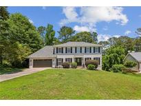 Charming two-story home boasts a well-manicured lawn and a classic design at 3145 Indian Hills Ne Dr, Marietta, GA 30068