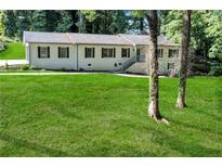 Traditional single-Gathering home showcasing a well-manicured lawn and landscaped front yard at 2418 Bolling Brook Sw Dr, Atlanta, GA 30311