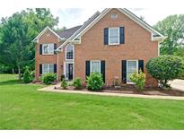 Charming two-story brick home with a well-manicured front yard and classic black shutters at 2420 Westport Cir, Marietta, GA 30064
