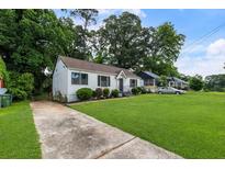 Charming single-story home with lush front lawn and a concrete driveway at 429 Deckner Sw Ave, Atlanta, GA 30310