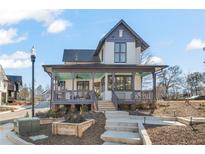 Charming two-story home features a covered front porch, landscaped yard, and classic architectural details at 1907 Galt, Kennesaw, GA 30144