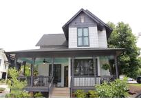 Charming home featuring a spacious covered front porch with beautiful views of the landscaped yard at 1907 Galt, Kennesaw, GA 30144