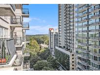 Scenic view from a high rise balcony overlooking the city skyline and lush greenery on a bright day at 195 14Th St # 902, Atlanta, GA 30309