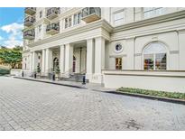 Elegant building exterior showcases a grand entrance with classic architectural details and manicured landscaping at 195 14Th St # 902, Atlanta, GA 30309