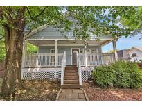 Charming home featuring a large front porch, well-maintained landscaping, and inviting curb appeal at 827 Fraser Se St, Atlanta, GA 30315