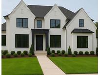 Stunning two-story home with a white brick facade, dark trim, lush lawn, and meticulously manicured landscaping at 2868 Octavia Cir, Marietta, GA 30062