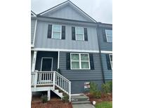Charming two-story townhome featuring neutral siding, black shutters, and a welcoming front porch at 2832 Saratoga Lake Vw, Decatur, GA 30034