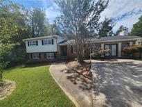 Charming two-story home with a well-maintained lawn, mature trees and long driveway at 3140 Kipling Dr, Powder Springs, GA 30127