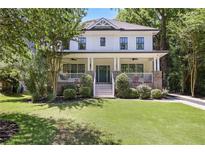 Charming two-story home with a welcoming front porch and lush green lawn at 1297 Conway Rd, Decatur, GA 30030