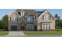 Stunning two-story brick home featuring attached garage and a well manicured lawn at 243 Deer Valley Run, Canton, GA 30115