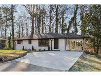 Charming brick home with a covered carport and well-manicured landscaping at 1120 Starline Se Dr, Smyrna, GA 30080