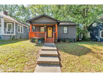 Charming home with a welcoming porch, warm wood accents, and a sunny yellow front door at 1336 Mcclelland Ave, Atlanta, GA 30344