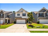 Charming two-story home with a well-manicured front yard and a two-car garage at 118 Woodhouse Cir, Acworth, GA 30102