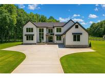 Stunning two-story modern farmhouse with sleek black accents and an expansive front yard at 1604 Greendale Rd, Covington, GA 30014