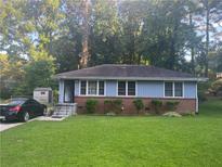 Charming single-story home featuring a well-maintained lawn and classic brick accents at 2530 Old Colony Rd, East Point, GA 30344