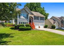 Charming two-story home with a well-manicured lawn and beautiful landscaping at 4426 High Gate Nw Dr, Acworth, GA 30101