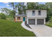 Charming two-story home with a front porch, freshly landscaped yard and a two-car garage at 4847 Royal Dr, Duluth, GA 30096