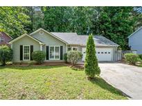 Charming home with attached garage, manicured lawn and mature trees at 4941 Lighthouse Pointe, Acworth, GA 30101
