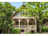 Charming craftsman home with a covered front porch, decorative railings, and lush landscaping creating curb appeal at 980 Faith Se Ave, Atlanta, GA 30316
