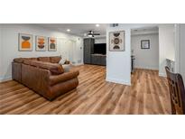 Spacious living room featuring hardwood floors, modern decor, and a comfortable leather sofa at 6980 Roswell Rd # B13, Sandy Springs, GA 30328