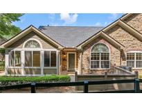Charming home featuring a stone and siding facade, complemented by well-manicured landscaping at 5336 Stone Village Nw Cir # 2, Kennesaw, GA 30152