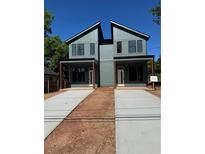 Modern duplex featuring striking architecture, gray siding, covered porches, and private driveways on a sunny day at 1223 Oakland Sw Dr # A, Atlanta, GA 30310