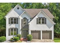 Charming two-story stucco home with a well-manicured lawn and attached two-car garage at 1097 Soaring Way, Marietta, GA 30062